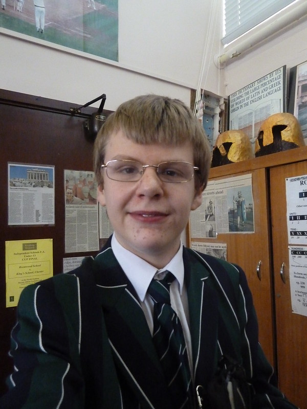 Me in school uniform with classical articles behind me