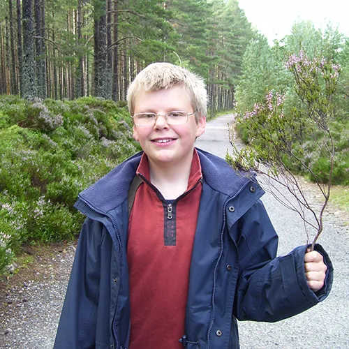 Me aged twelve holding a sprig of heather